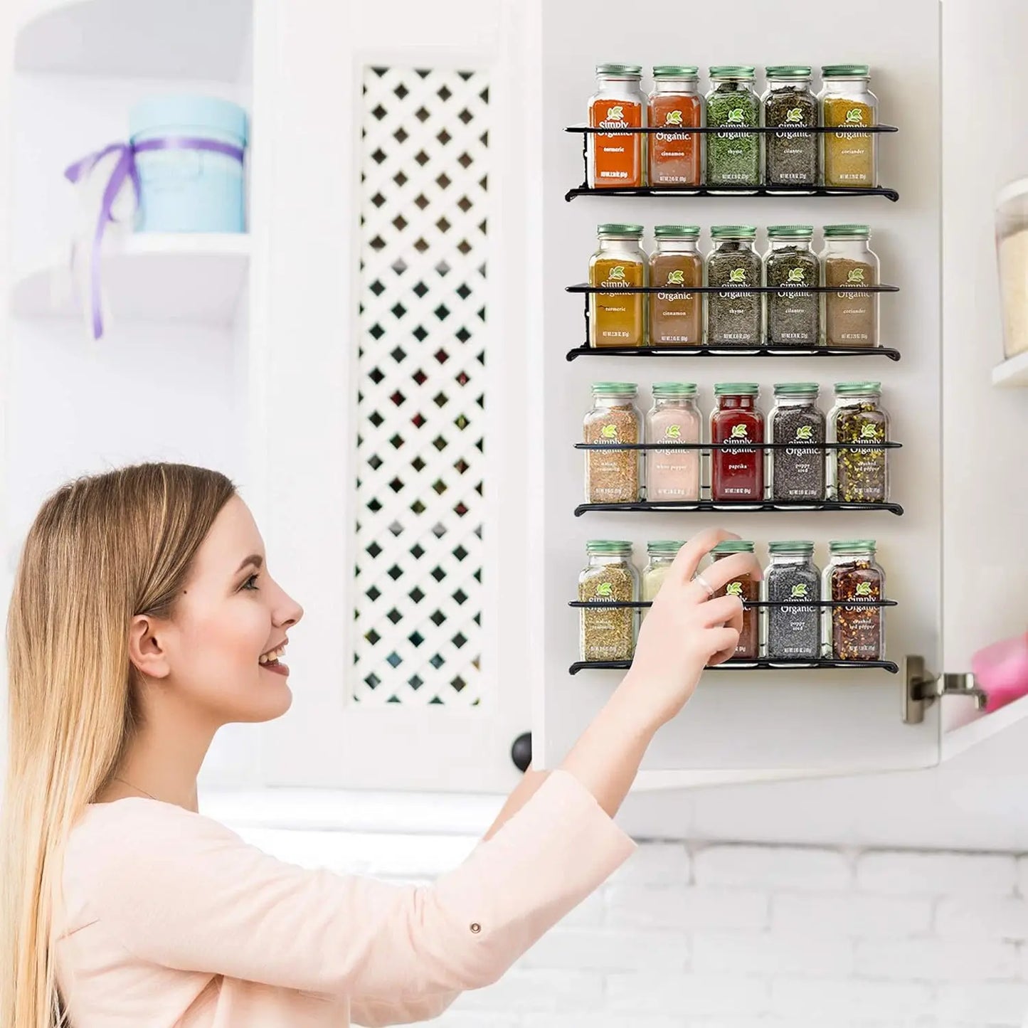 Kitchen spice storage rack mounted inside cabinet with labeled jars