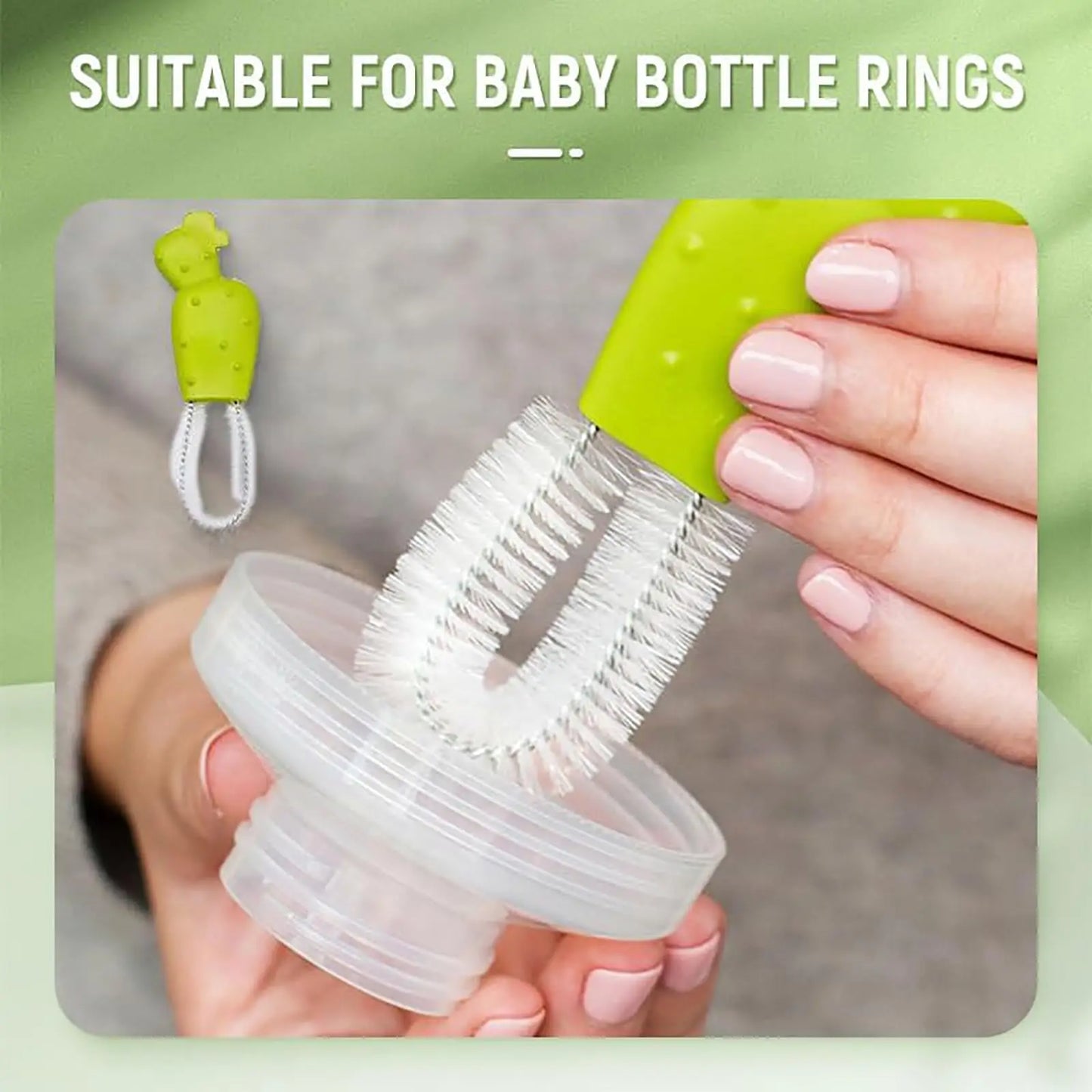 Green bottle brush with clear bristles being used on a baby bottle against a green background
