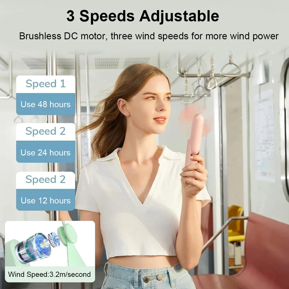 Woman using a handheld fan with speed settings displayed, in a bus or metro setting.