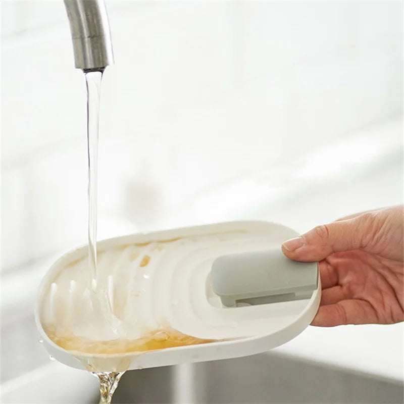 spatula and lid holder being washed in a sick