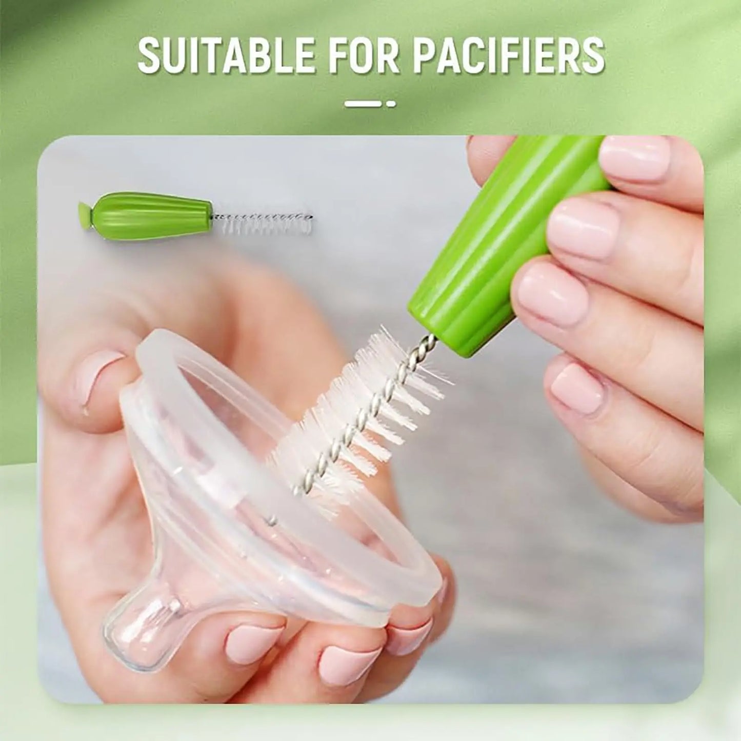 Person using a green pacifier cleaner on a clear pacifier with a green background.