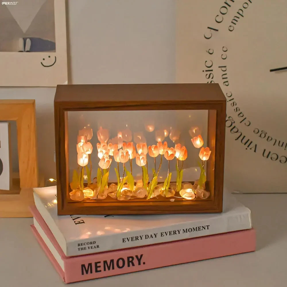 Warm LED tulip flower light box on stacked books, part of a DIY wooden craft kit for cozy home decoration