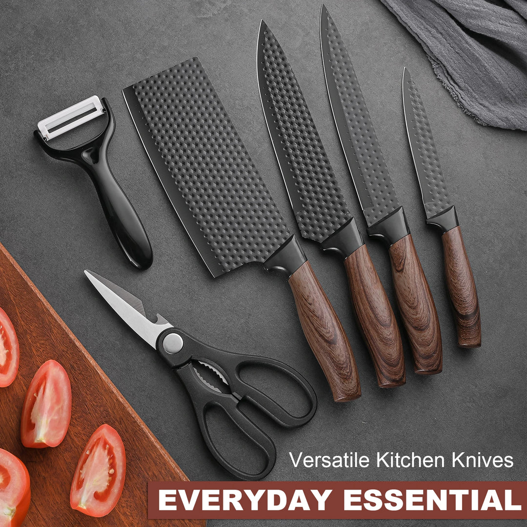 Set of kitchen knives with a cutting board, tomatoes, and a peeler on a gray surface.