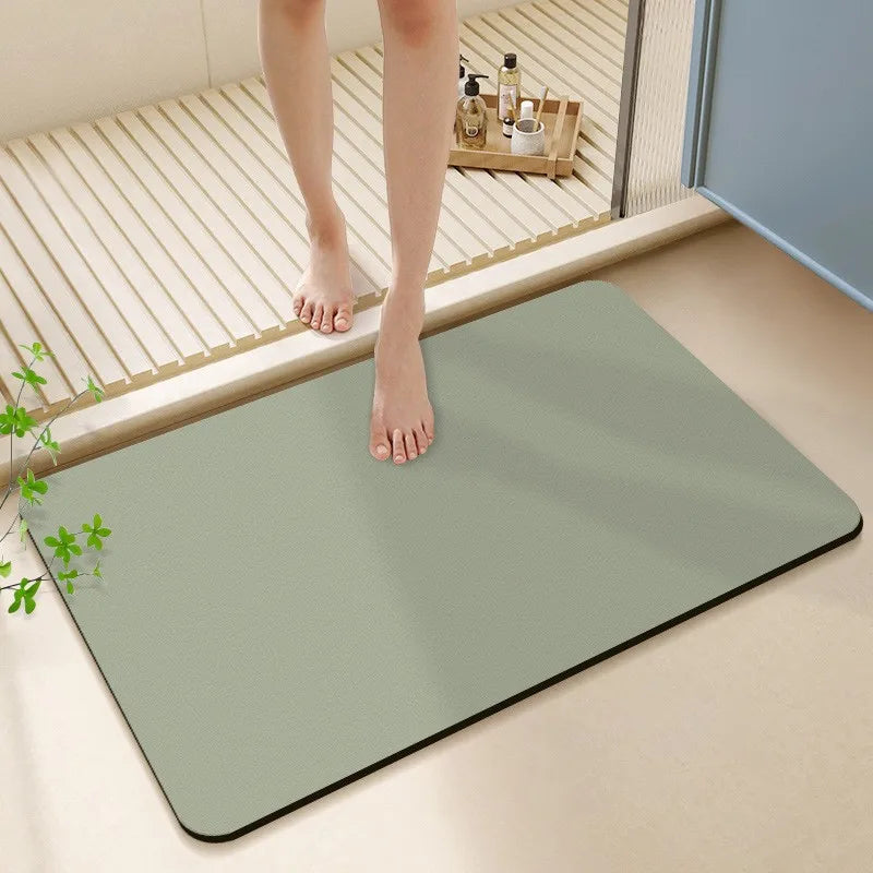 Person stepping onto a green bath mat in a bathroom setting