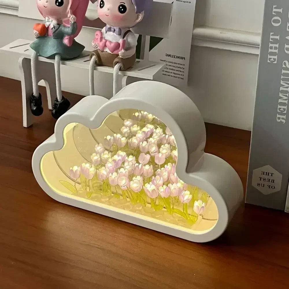 Cloud-shaped DIY Tulip Flower Garden Light Box with glowing white blooms and mirrored background, placed on a wooden desk
