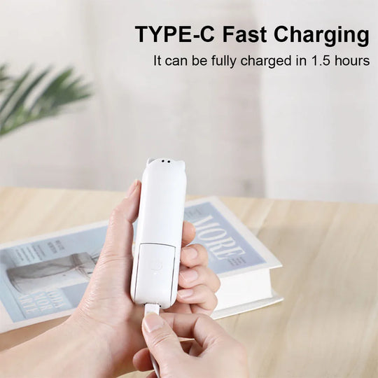 Hand holding a white USB-C charging min fan with text about fast charging on a blurred background.