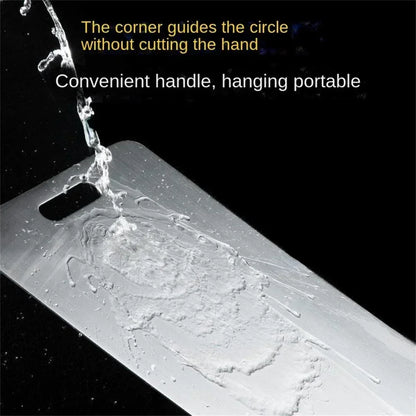 Water rinsing over a stainless steel cutting board with a convenient handle, highlighting easy cleaning and safe rounded corners