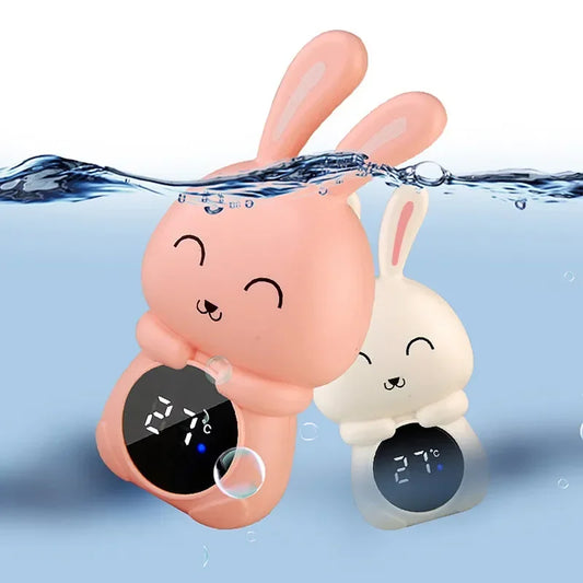 Floating bunny-shaped baby bath thermometer displaying 27°C in water