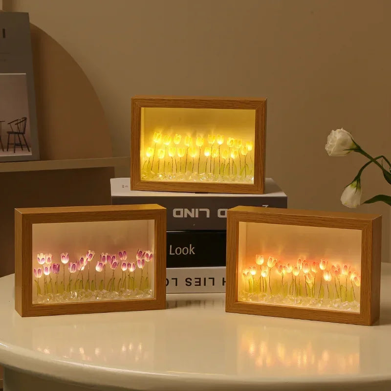 DIY wooden tulip light box kits with LED floral displays in warm tones, arranged on a table and books for home decor