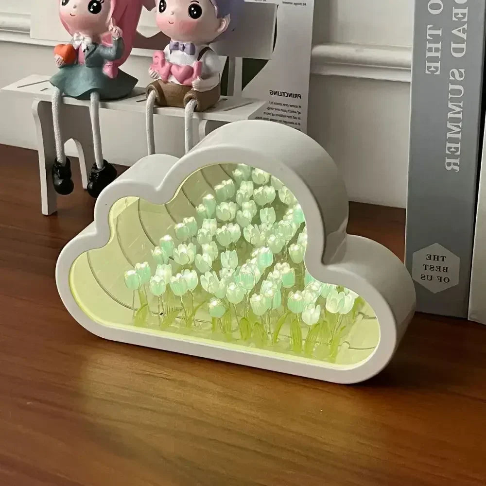 Cloud-shaped DIY Tulip Flower Garden Light Box with glowing white blooms and mirrored background, placed on a wooden desk