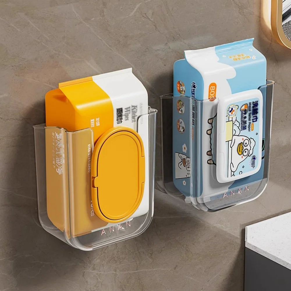 Two transparent wall-mounted wipes dispensers holding colorful wet wipe packs on a bathroom wall