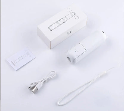White electronic portable mini fan with USB cable and packaging on a light gray background